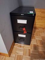 Front view showing two drawers, label holders, handles and lock