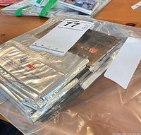 Bag of sealed silver foil hockey card packs in Ziploc bag