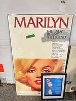 Front view of Marilyn Monroe poster with Cat in the Hat print beside it