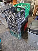 Stack of six plastic milk crates in assorted colours