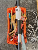 Top view of orange rolling tool caddy filled with tools and straps