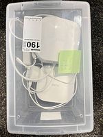 Top view of two Eero Wi-Fi boosters, power adapters and cables in clear tote