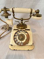 Front view showing rotary dial, brass fittings, enamel chips