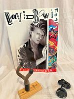 Front view of Bowie tour program, guitar hanger, tuner
