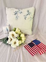 Group shot of pillow, artificial flowers, flags, Mobile Klean box