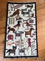 Full view of the handwoven rug showing entire design and fringe