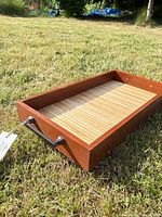 Full view of rectangular reclaimed wood tray placed on grass