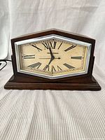 Front view showing dial, bezel, wood case