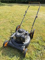 Full view of Poulan Pro push lawn mower on grass