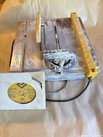 Top view of QEP wet tile saw with rip fence and packaged diamond blade