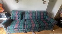Full front view of the three-seat sofa showing overall design and pattern