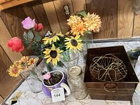 Front view showing all floral stems, vases, jar, mug planter, metal box with wire inserts