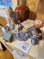 Group view of all figurines and trinket boxes on shelf