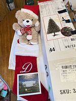 Boxed Celebrate It pre-lit 4 ft tree, red monogrammed stocking, plush teddy bear, White House ornament box on table