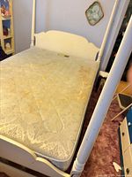 Full view of bed frame with mattress in place showing headboard, posts and finish