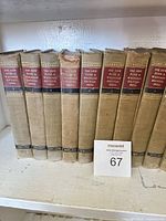 Left section of shelf showing 8 early-number volumes with tan cloth covers