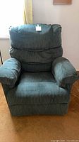 Front view of green corduroy recliner upright
