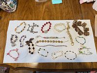 Overhead view of entire lot of 17 bracelets on towel background