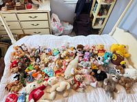 Full lot spread on bed showing all plush items