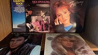 Five LP covers: Country Rock compilation, two Rick Springfield titles, Tiffany self-titled, unidentified female artist; visible sleeve wear
