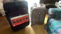 Both suitcases side by side for scale and color comparison