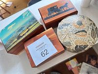 Four boxes closed showing lid designs and wood grain