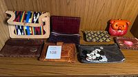 All eight purses and pouches displayed on shelf