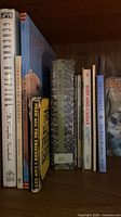 Shelf view showing spines of assorted hardcover, paperback and board books