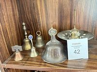 Group shot of all six bells on shelf