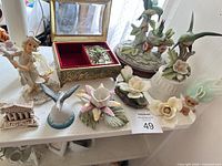 full lot view with figurines, trinket box, troll