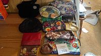 Group shot of all 11 small purses, wallets and pouches on desk