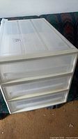 Three stacked plastic drawer units showing front view