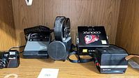 Shelf view of all four cameras, straps, case and COOLPIX box visible