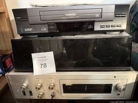 Toshiba VCR atop black object and Pilot receiver below