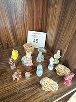 Full lot overview showing all miniature figurines grouped on shelf