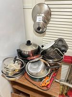 Overall view of stacked cookware, bakeware, tools