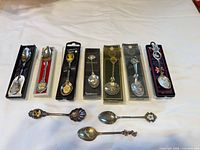 Overview of all boxed and loose spoons on table