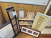 Overall group showing frames, signs, shelf and small ceramics