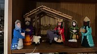Front view of all figures and wooden stable on shelf