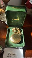 Closed Precision pocket watch with chain in original green box