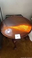 Top view of round mahogany veneer end table showing surface and finish