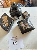 all four black ceramic pieces with lids closed