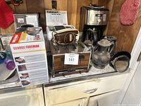 All appliances and kettles arranged on countertop