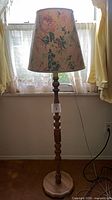 Full view of floor lamp showing base and shade
