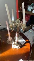 Brass and wood 5-arm candelabra with candles, glass candlestick, deer holder