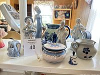 Group shot of all blue and white porcelain figurines and pottery pieces