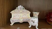 Front view of trinket box and egg planter showing design, glaze and gilt