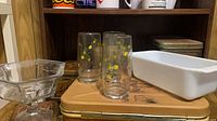Overview of tumblers, milk glass pan, compote, bread tin