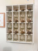 Front view of rack showing 12 glass bottles in 3×4 grid