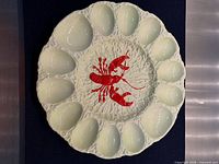 Front view of platter showing lobster motif and 12 wells
